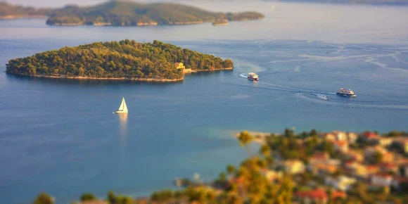 Yacht anchored off a golden Greek beach with turquoise water